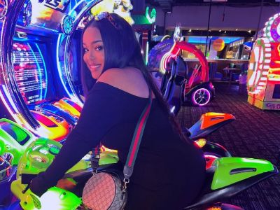 Donielle Nash is playing a bike racing game in the picture.